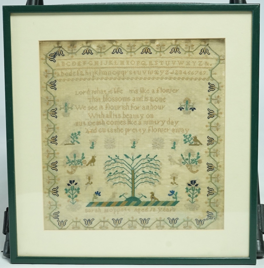 An early 19th century very finely embroidered sampler, by Sarah Hoppett aged 12 years. Embroidered with an alphabet, verse and a central panel depicting the tree of life, birds, cornucopia and flowers, within a floral vi